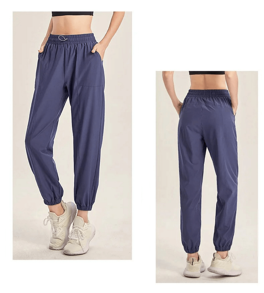 Women's blue drawstring joggers for yoga and gym, featuring elastic waist and cuffs, shown front and back, ideal for running and dance.
